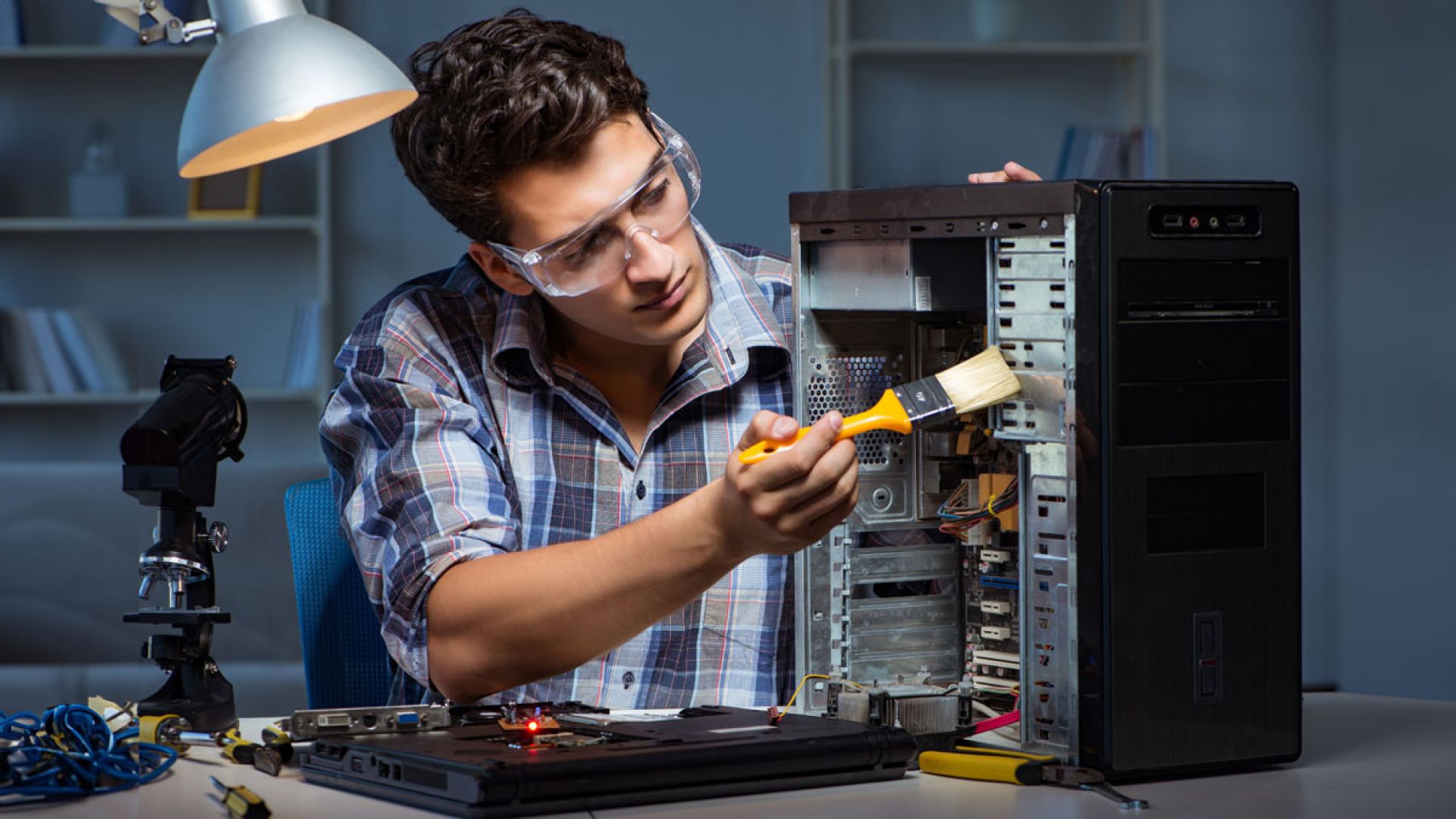 man working on computer hardware
