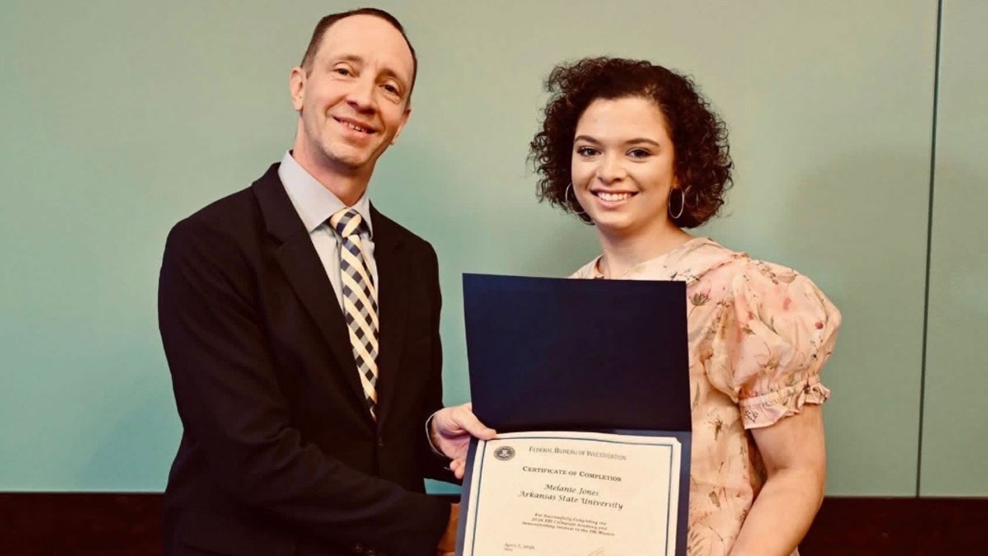 Melanie Jones with completion certificate for FBI collegiate academy